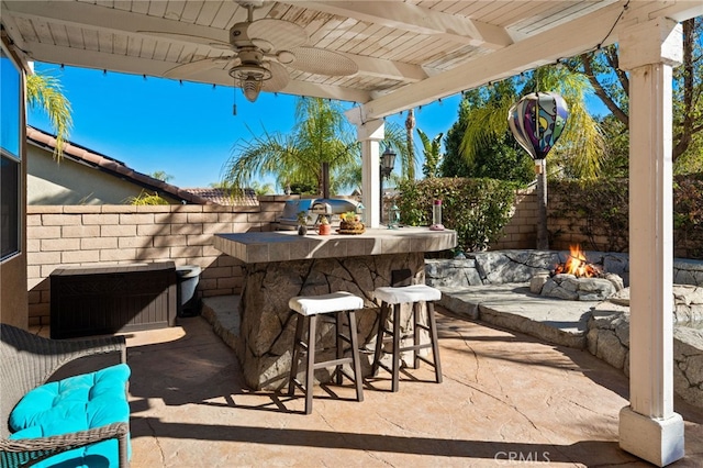 view of patio with area for grilling and an outdoor bar