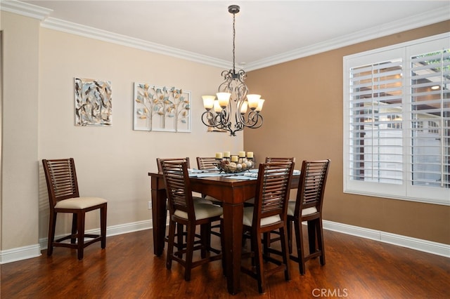 dining space featuring dark hardwood / wood-style floors, crown molding, and a chandelier