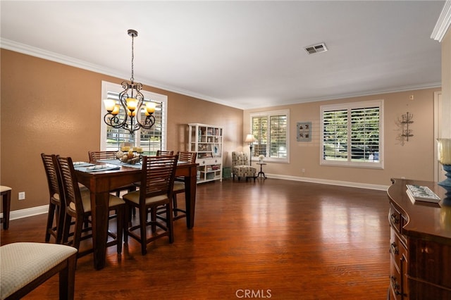 dining room featuring a chandelier, ornamental molding, a wealth of natural light, and dark wood-type flooring