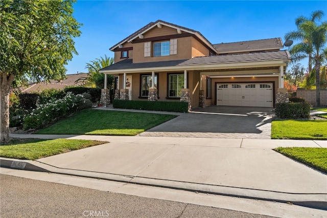 craftsman inspired home with a porch, a garage, and a front lawn