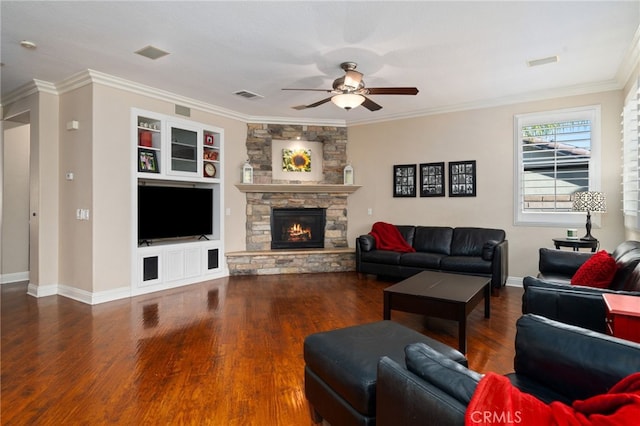 living room with a fireplace, dark hardwood / wood-style flooring, ceiling fan, and ornamental molding