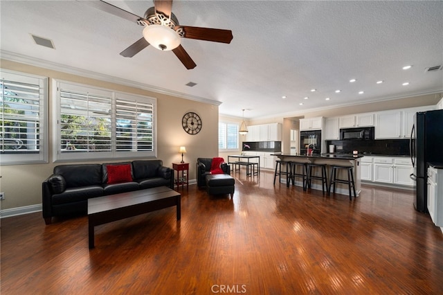 living room featuring crown molding and dark hardwood / wood-style flooring