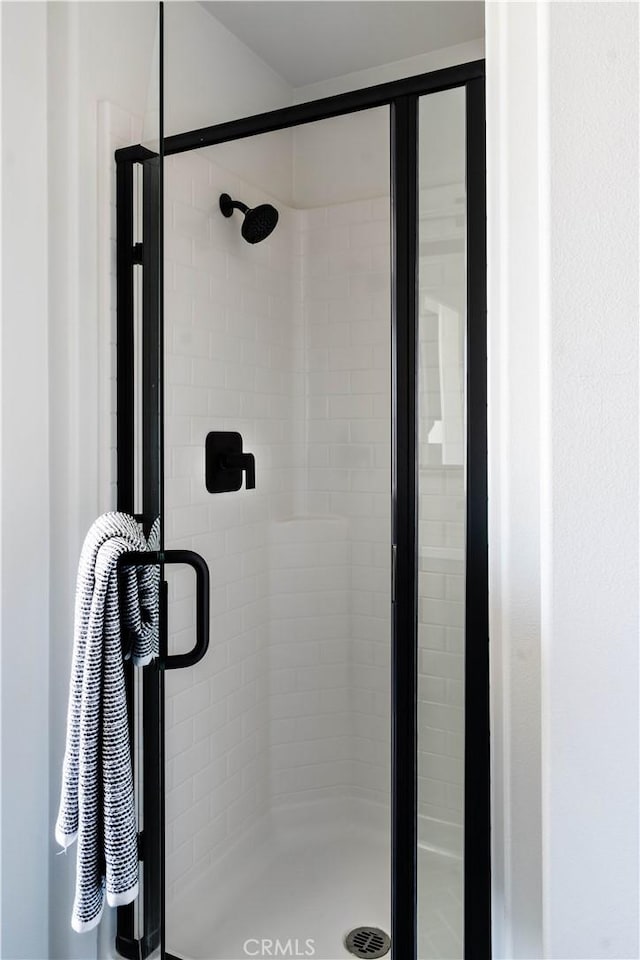 bathroom featuring a shower with door