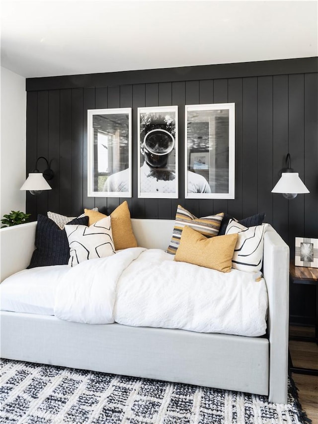 living room featuring hardwood / wood-style floors and wooden walls