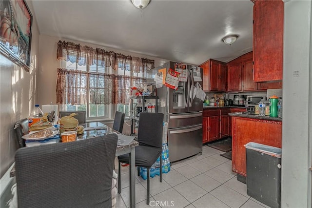 kitchen with stainless steel fridge and light tile patterned floors