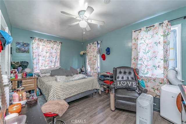 bedroom with hardwood / wood-style floors and ceiling fan