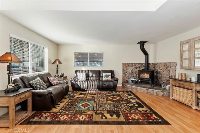 living room with hardwood / wood-style floors and a wood stove