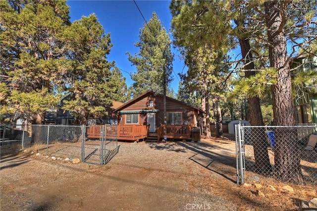 exterior space featuring a storage shed and a wooden deck