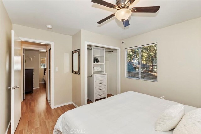 bedroom featuring ceiling fan, a closet, and light hardwood / wood-style floors