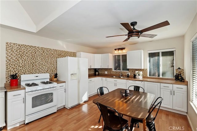 kitchen featuring backsplash, white appliances, sink, light hardwood / wood-style flooring, and white cabinets