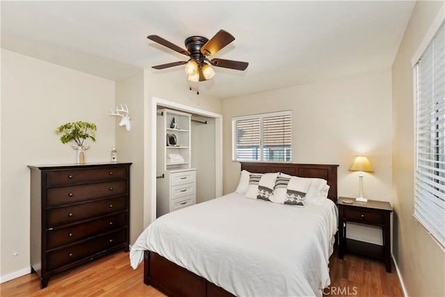 bedroom with hardwood / wood-style floors, ceiling fan, and a closet