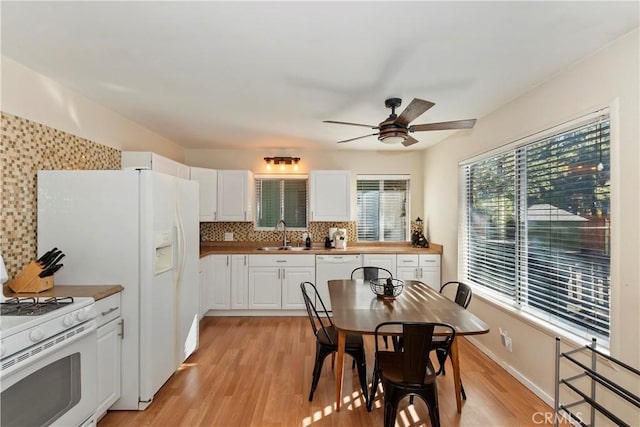 kitchen with white cabinetry, sink, backsplash, white appliances, and light wood-type flooring