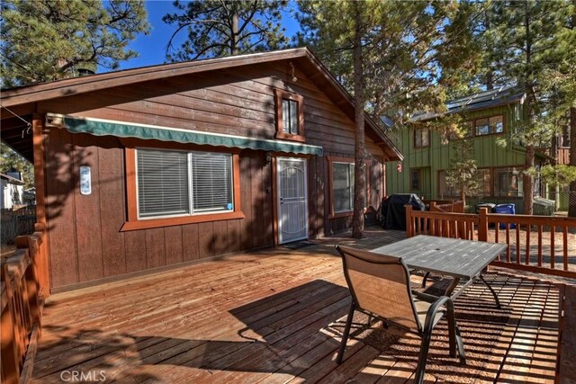 wooden deck with a grill