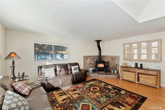 living room with hardwood / wood-style flooring and a wood stove