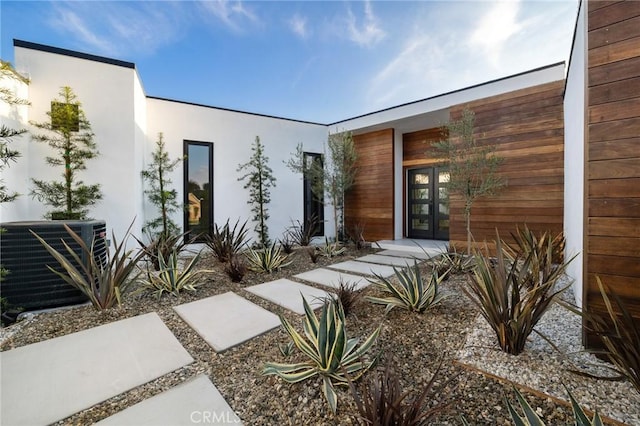 property entrance featuring central AC unit