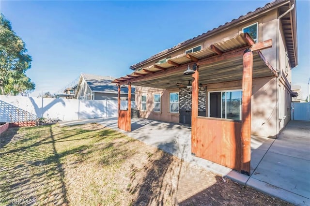 exterior space with ceiling fan