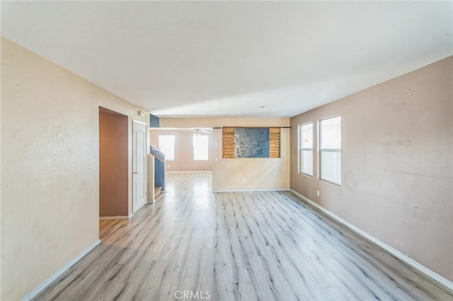 unfurnished room with a healthy amount of sunlight and light hardwood / wood-style floors