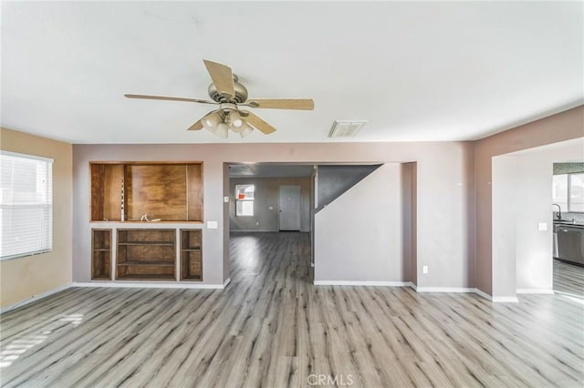 unfurnished living room with ceiling fan, plenty of natural light, and light hardwood / wood-style floors