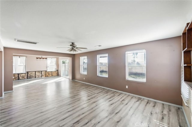 spare room with ceiling fan and light hardwood / wood-style floors