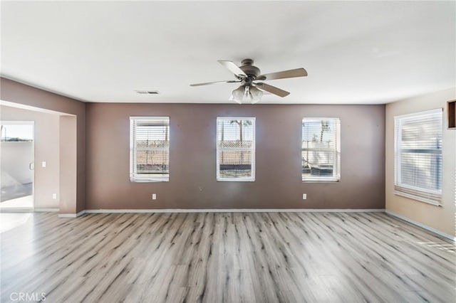 spare room featuring light wood-type flooring and ceiling fan