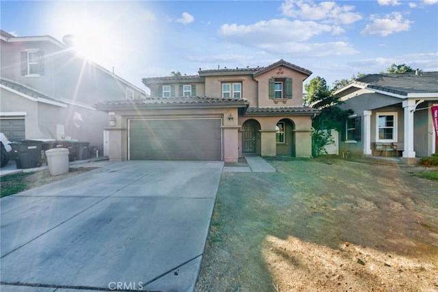 mediterranean / spanish house with a garage