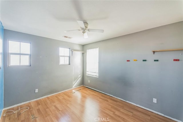 spare room featuring hardwood / wood-style floors and ceiling fan