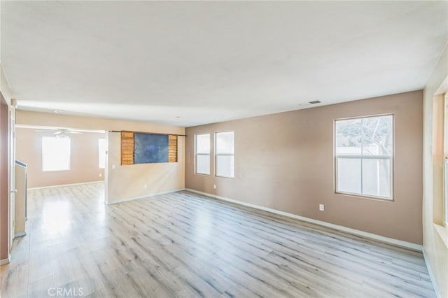 spare room featuring plenty of natural light and light wood-type flooring