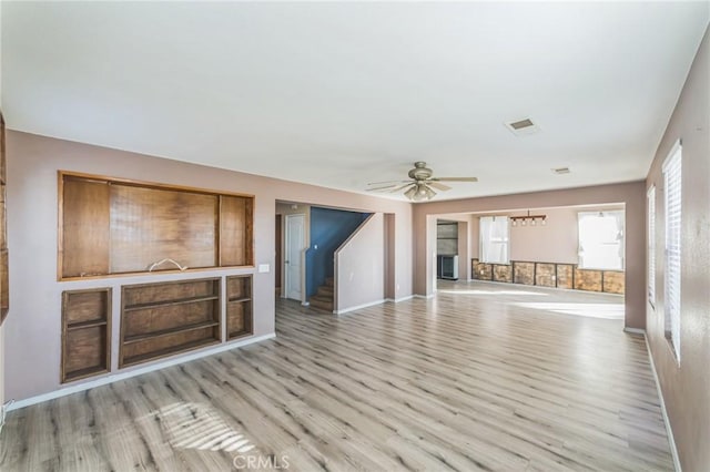 unfurnished living room featuring ceiling fan and light hardwood / wood-style flooring