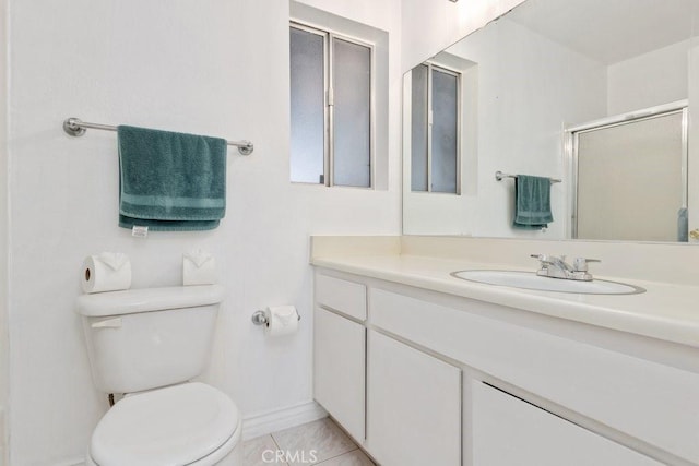 bathroom featuring tile patterned floors, vanity, an enclosed shower, and toilet