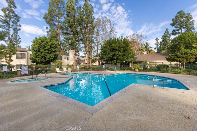 view of pool with a community hot tub and a patio