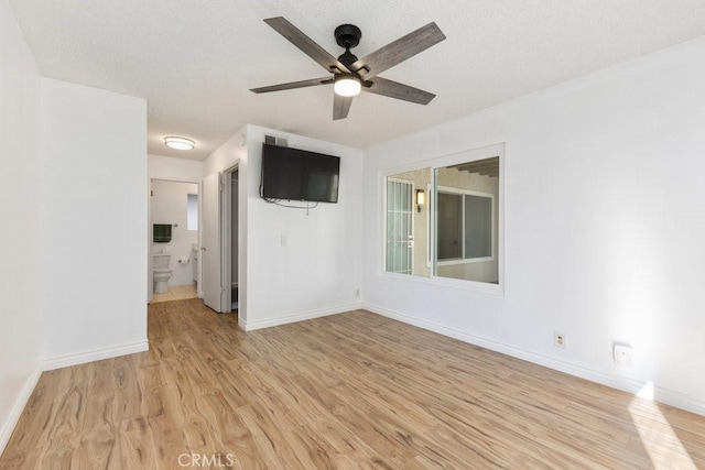 empty room featuring ceiling fan and light wood-type flooring