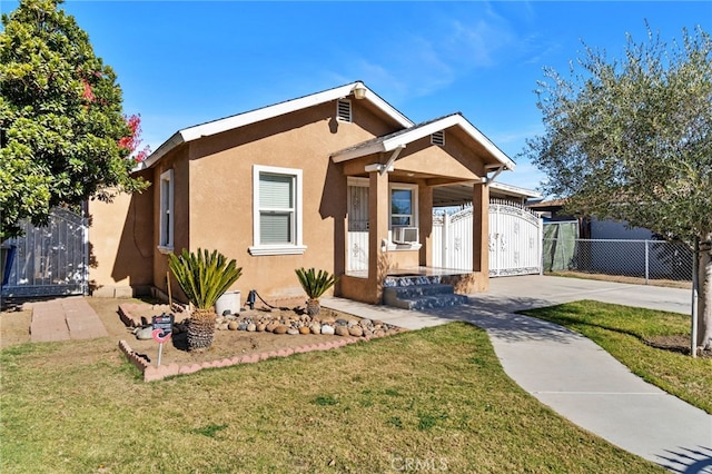 bungalow featuring cooling unit and a front lawn