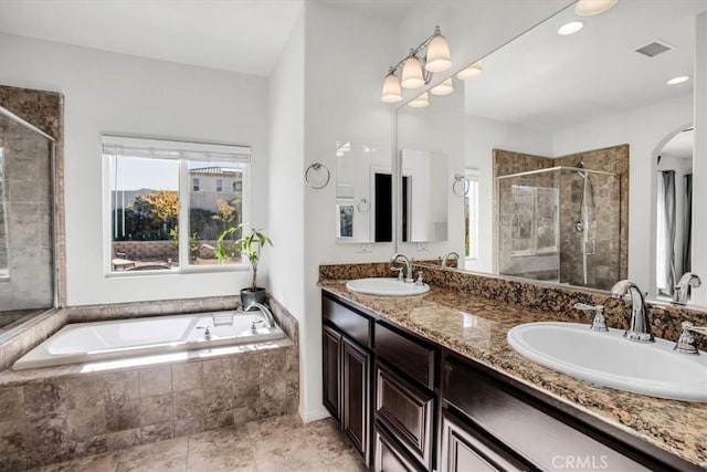 bathroom featuring vanity and shower with separate bathtub