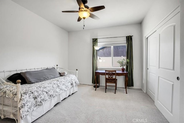 carpeted bedroom featuring a closet and ceiling fan