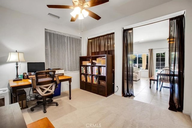 office with ceiling fan and light carpet