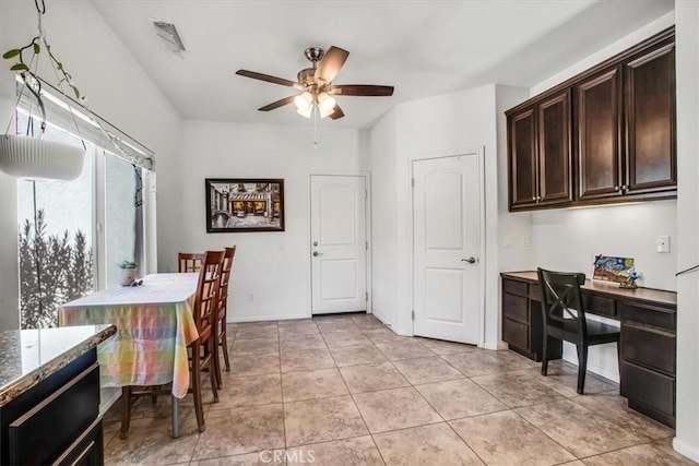 interior space featuring light tile patterned floors and ceiling fan