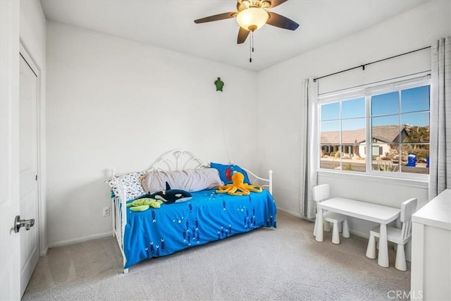 carpeted bedroom featuring ceiling fan