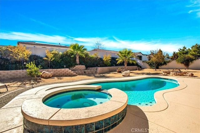 view of pool with an in ground hot tub