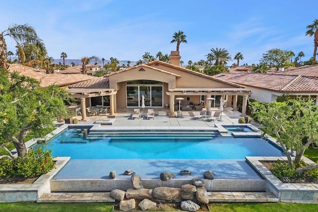 view of pool with a patio area and an in ground hot tub