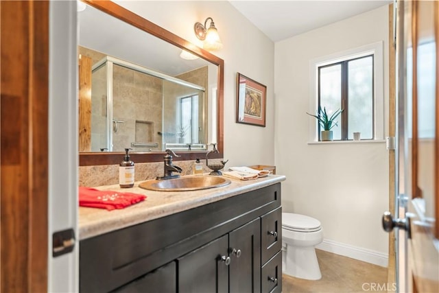 full bath featuring a stall shower, tile patterned floors, toilet, vanity, and baseboards
