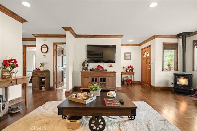 living room featuring crown molding, a wood stove, and dark wood-type flooring