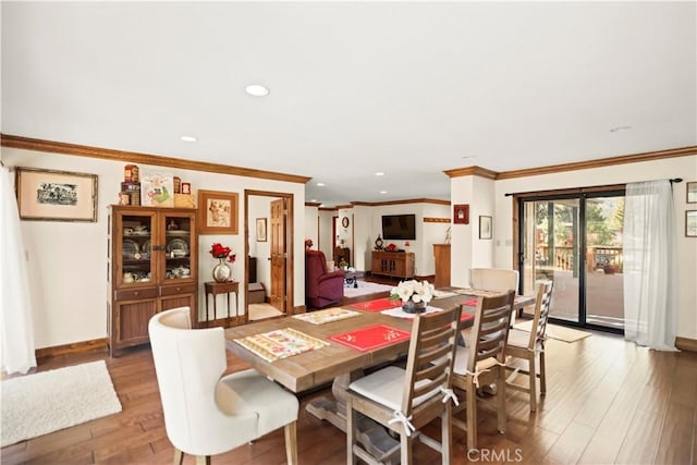 dining area with recessed lighting, ornamental molding, baseboards, and light wood-type flooring