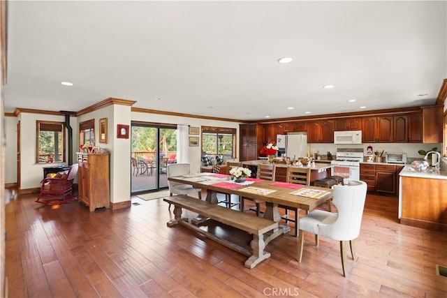 dining area with recessed lighting, hardwood / wood-style flooring, and crown molding