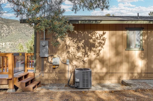 exterior space with central AC unit and electric meter