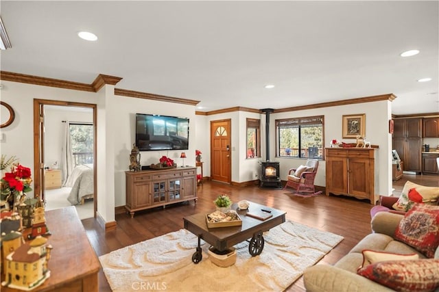 living room with dark hardwood / wood-style flooring, a wood stove, and ornamental molding