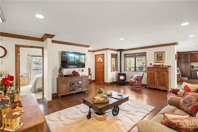 living room featuring recessed lighting, dark wood-type flooring, baseboards, and a wood stove