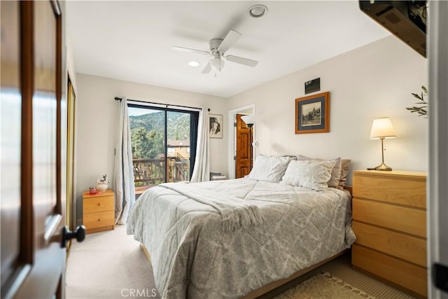bedroom with access to exterior, a ceiling fan, and light carpet