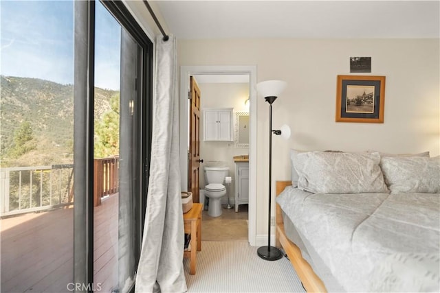 carpeted bedroom with ensuite bathroom