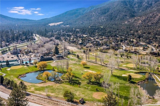 bird's eye view with a water and mountain view and view of golf course