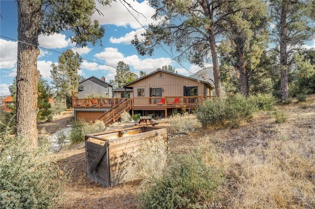 back of house featuring a wooden deck